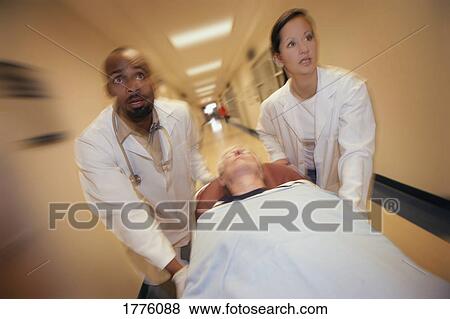 Doctors moving stretcher View Large Photo Image Stock Photo - Doctors moving stretcher. Fotosearch