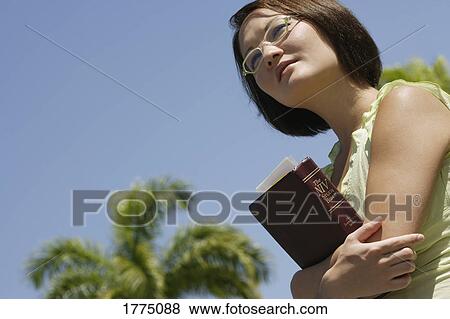 Female student carrying her study bible View Large Photo Image Stock Photo - Female student carrying her study bible. Fotosearch