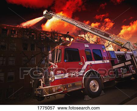 Fire fighters and fire truck putting out fire View Large Photo Image Stock Photo - Fire fighters and fire truck putting out fire. Fotosearch