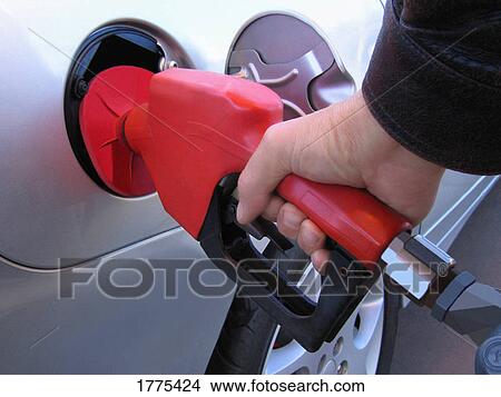 Picture - Gas nozzle in car. Fotosearch