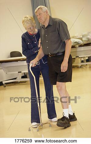 Stock Photo - Helping someone walk. Fotosearch