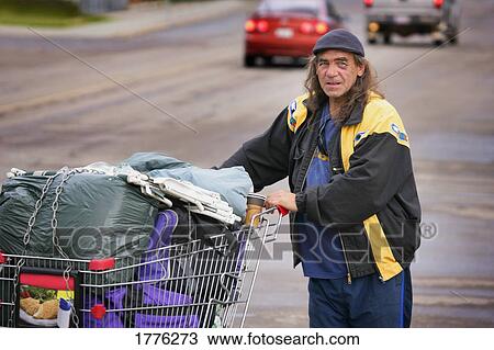 Homeless man with his belongings in shopping trolley View Large Photo Image Stock Image - Homeless man with his belongings in shopping trolley. Fotosearch