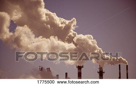 Stock Image - Industrial chimneys and fumes. Fotosearch