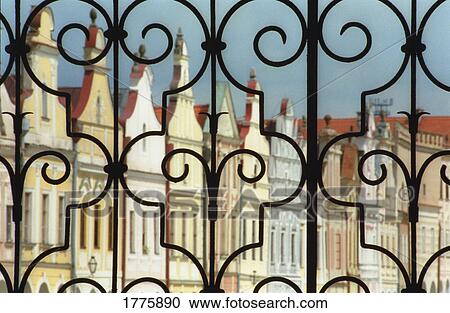 Stock Image - Iron gate with building in background. Fotosearch