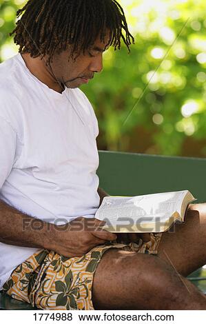 Stock Photo - Jamaican man reading. Fotosearch