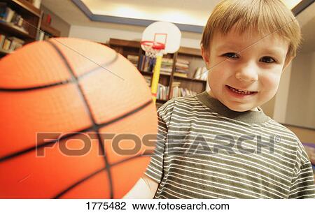 Stock Image - Little boy with basketball. Fotosearch
