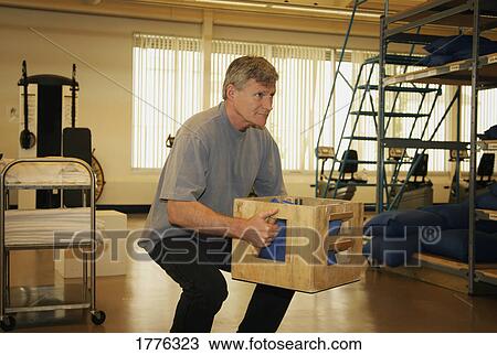 Stock Image - Man during rehab after injury. Fotosearch