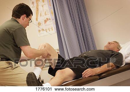 Man having leg stretched View Large Photo Image Stock Image - Man having leg stretched. Fotosearch