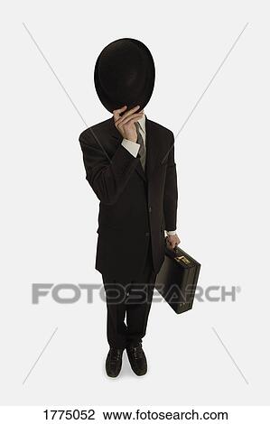 Man hiding behind his hat View Large Photo Image Stock Image - Man hiding behind his hat. Fotosearch