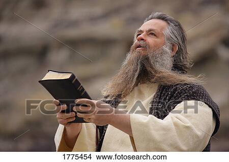 Man holding Bible View Large Photo Image Picture - Man holding Bible. Fotosearch