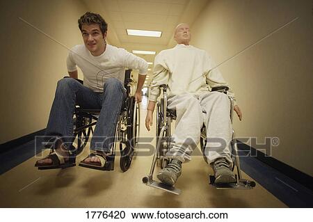 Man in wheelchair racing in hallway View Large Photo Image Stock Image - Man in wheelchair racing in hallway. Fotosearch