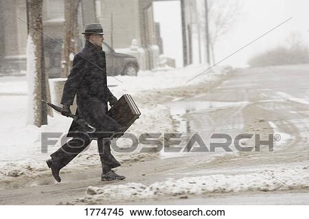 Stock Photography - Man walking in winter weather. Fotosearch