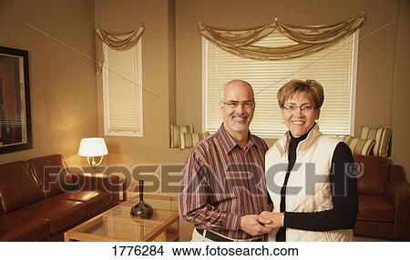 Picture - Mature couple in a contemporary living room. Fotosearch
