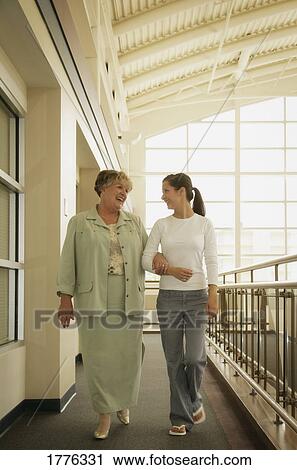 Mother and daughter inside a public building View Large Photo Image Stock Image - Mother and daughter inside a public building. Fotosearch
