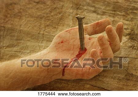 Picture - Nail in hand. Fotosearch