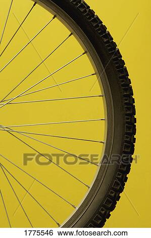 Part of a bicycle wheel against yellow background View Large Photo Image Stock Photograph - Part of a bicycle wheel against yellow background. Fotosearch