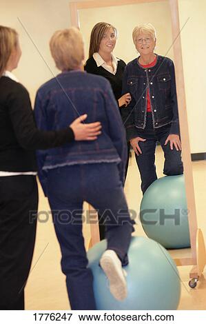 Physiotherapist helping a patient View Large Photo Image Stock Photo - Physiotherapist helping a patient. Fotosearch