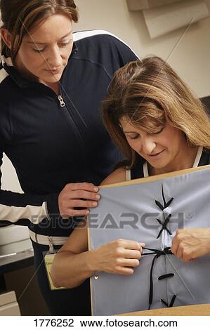 Stock Image - Physiotherapist working with a patient. Fotosearch