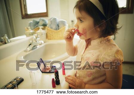 Stock Photo - Playing with mommy's makeup. Fotosearch
