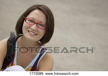 Stock Photo - Portrait of a pretty girl with a backpack. Fotosearch