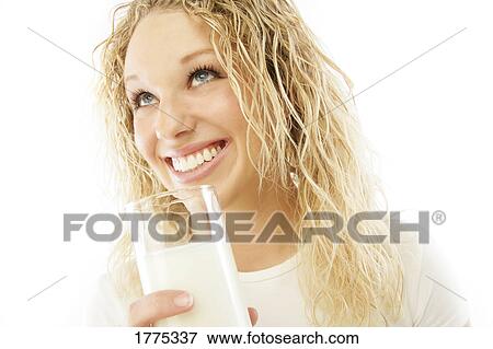 Pretty girl drinking a glass of milk View Large Photo Image Stock Photo - Pretty girl drinking a glass of milk. Fotosearch