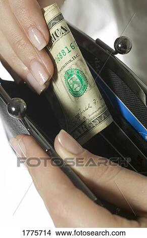 Putting money in purse View Large Photo Image Picture - Putting money in purse. Fotosearch