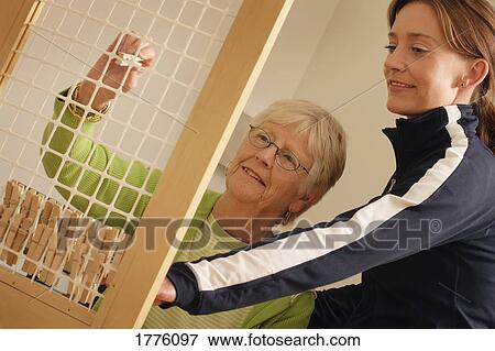 Picture - Senior with therapist. Fotosearch - Search Stock Photography, Photos, Prints, Images, and Photo Clipart