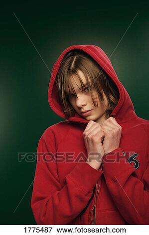 Stock Photo - Serious teenage girl wearing red hooded top. Fotosearch