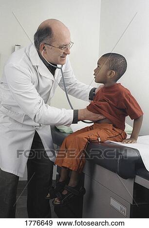 Stock Photo - small boy having a check-up. Fotosearch