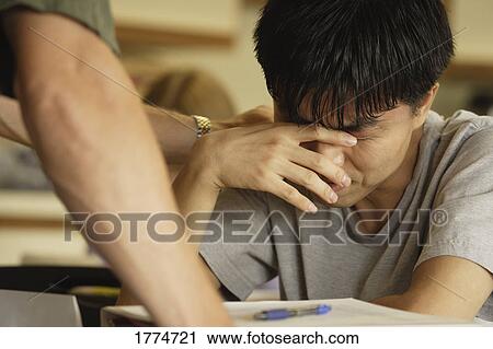 Student in distress crying at their desk View Large Photo Image Stock Image - Student in distress crying at their desk. Fotosearch