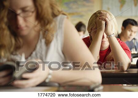 Stock Image - Students at a bible study and prayer class. Fotosearch