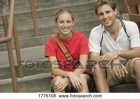 Teenage smiling couple sitting on cement steps View Large Photo Image Stock Photography - Teenage smiling couple sitting on cement steps. Fotosearch