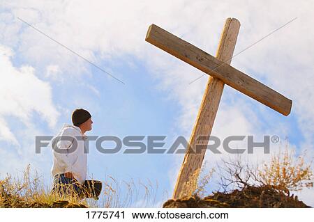 Teenager standing at cross View Large Photo Image Stock Image - Teenager standing at cross. Fotosearch