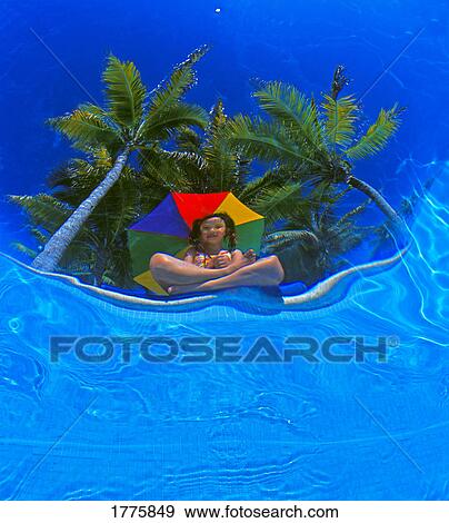 Stock Photo - Underwater view of girl at the poolside. Fotosearch