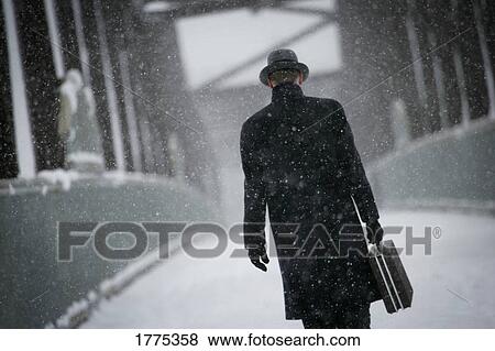 Walking across a wintry bridge View Large Photo Image Stock Photo - Walking across a wintry bridge . Fotosearch