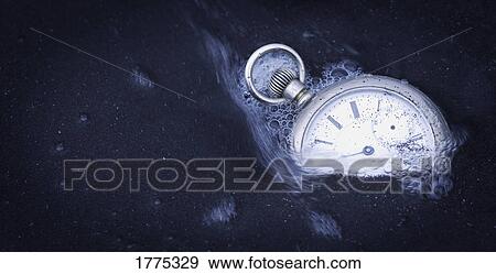Watch being swept away by water as it is surrounded by sand View Large Photo Image Stock Photo - Watch being swept away by water as it is surrounded by sand. Fotosearch