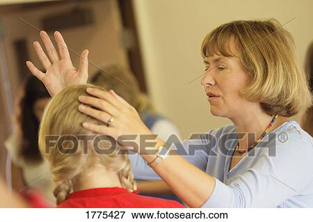 Stock Photo - Woman praying for teen. Fotosearch