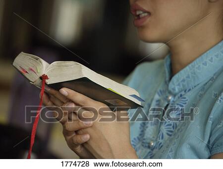 Woman reading from the Bible View Large Photo Image Stock Photo - Woman reading from the Bible. Fotosearch