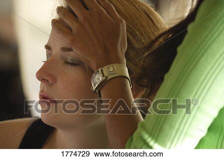 Woman with hand on another woman's forehead View Large Photo Image Stock Photo - Woman with hand on another woman's forehead. Fotosearch