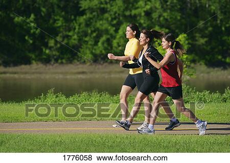 Women walking on path View Large Photo Image Stock Photo - Women walking on path. Fotosearch