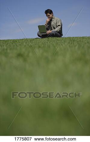 Stock Photo - Working outdoors on a laptop. Fotosearch