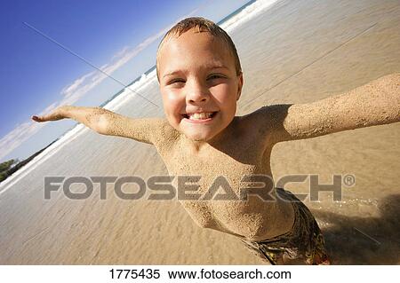 Young boy covered with sand View Large Photo Image Stock Photography - Young boy covered with sand. Fotosearch
