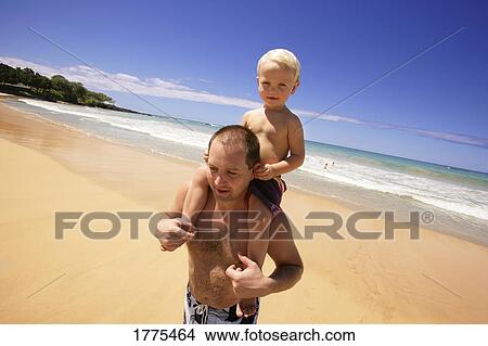 Young boy on dad's shoulders View Large Photo Image Picture - Young boy on dad's shoulders. Fotosearch