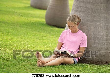 Young girl absorbed in her book View Large Photo Image Stock Image - Young girl absorbed in her book. Fotosearch
