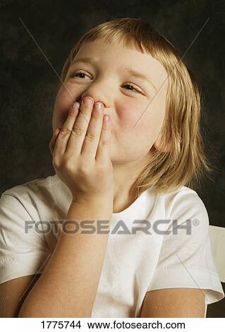 Young girl with hand over mouth View Large Photo Image Picture - Young girl with hand over mouth. Fotosearch