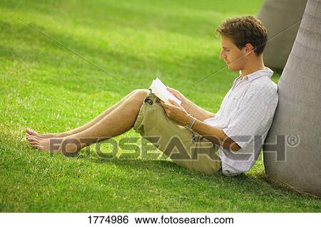 Stock Photograph - Young man reading. Fotosearch