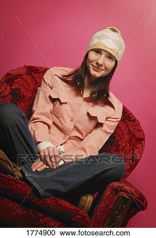 Young trendy teenage girl sitting cross-legged View Large Photo Image Stock Image - Young trendy teenage girl sitting cross-legged. Fotosearch