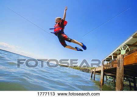 A boy jumps into the lake View Large Photo Image Stock Image - A boy jumps into the lake. Fotosearch
