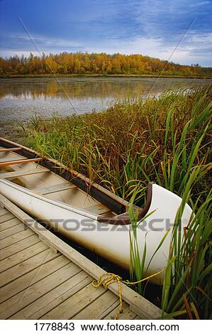 A canoe tied up to a dock View Large Photo Image Stock Image - A canoe tied up to a dock. Fotosearch