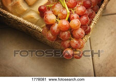 A close-up (close up closeup) of red grapes and bread View Large Photo Image Stock Image - A close-up (close up closeup) of red grapes and bread. Fotosearch